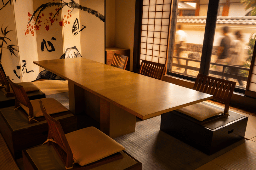 PrevieA tranquil, empty Japanese-style room featuring a low wooden table and traditional screens, while blurred figures can be seen walking quickly past the window outside.w